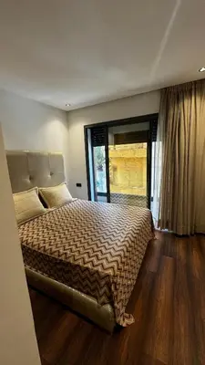 a bedroom with a large bed with a large window at Luxurious Studio in Casablanca in Casablanca