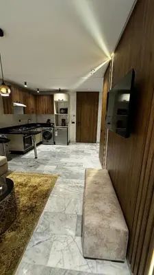 a large room with a kitchen with a tv on a wall at Luxurious Studio in Casablanca in Casablanca