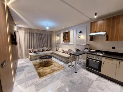 a large living room with a couch and a table at Luxurious Studio in Casablanca in Casablanca