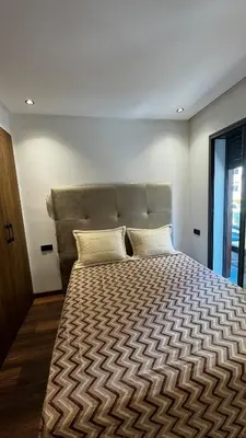 a bedroom with a large bed with a large headboard at Luxurious Studio in Casablanca in Casablanca