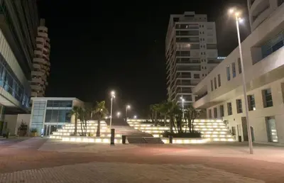 a group of stairs in a city at night at Appartement entier 2 chambres marina avec vue panoramique mer in Casablanca