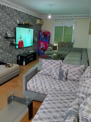 a living room with a couch and a flat screen tv at AZEMMOUR appart in Azemmour