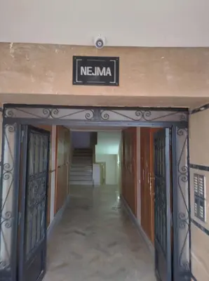 an entrance to a building with a sign that reads nenna at AZEMMOUR appart in Azemmour