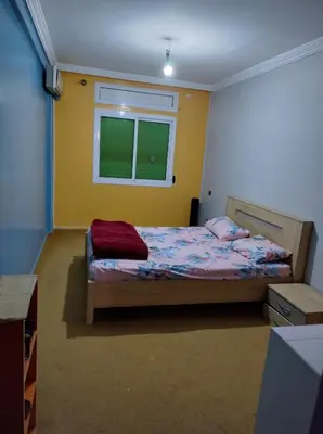 a bedroom with a bed and a window at AZEMMOUR appart in Azemmour