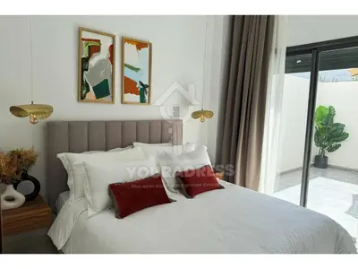 a bedroom with a white bed with two red pillows at Youradress Casablanca - Maarif in Casablanca