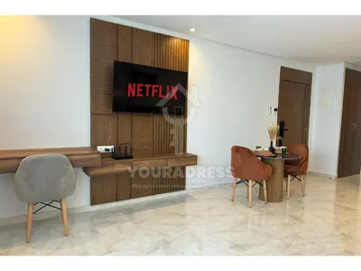 a living room with a television on a wall at Youradress Casablanca - Maarif in Casablanca