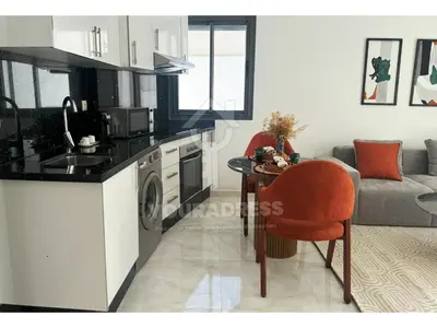 a kitchen and a living room with a table at Youradress Casablanca - Maarif in Casablanca