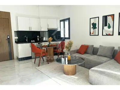 a living room with a couch and a table at Youradress Casablanca - Maarif in Casablanca