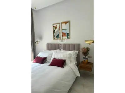 a bedroom with a white bed with red pillows at Youradress Casablanca - Maarif in Casablanca