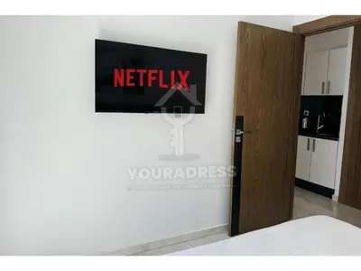 a room with a netflix sign on the wall at Youradress Casablanca - Maarif in Casablanca