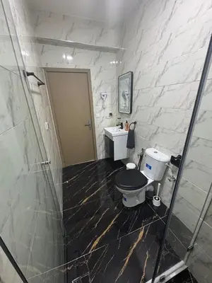 a bathroom with a toilet and a sink at Appartement Casablanca près de la mer in Dar Bouazza