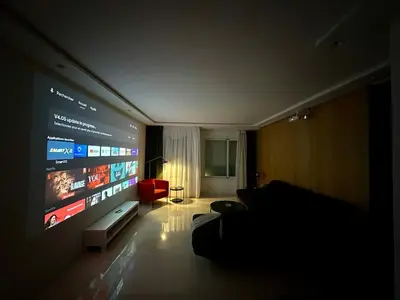 a living room with a large flat screen tv at Luxury Oasis Apartment -Rooftop Pool & Home Cinema in Casablanca