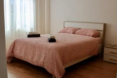 a bedroom with a bed with a teddy bear on it at Luxury Oasis Apartment -Rooftop Pool & Home Cinema in Casablanca