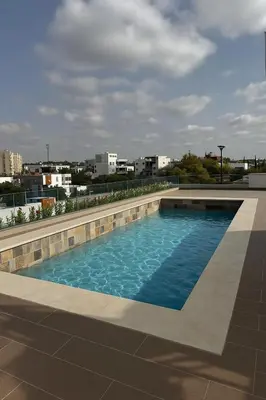 a swimming pool on the roof of a building at Luxury Oasis Apartment -Rooftop Pool & Home Cinema in Casablanca