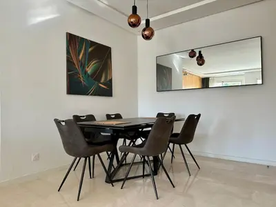 a dining room with a table and chairs at Luxury Oasis Apartment -Rooftop Pool & Home Cinema in Casablanca