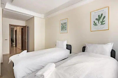 two beds sitting next to each other in a room at Spacious & Central 3 bedrooms-Casablanca Center in Casablanca