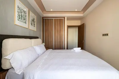 a bedroom with a large bed with white sheets at Spacious & Central 3 bedrooms-Casablanca Center in Casablanca