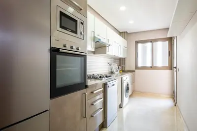 a kitchen with a stove and a microwave at Spacious & Central 3 bedrooms-Casablanca Center in Casablanca
