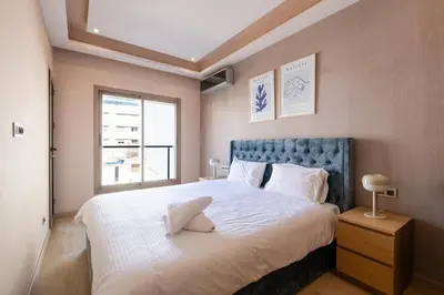 a bedroom with a large bed and a window at Spacious & Central 3 bedrooms-Casablanca Center in Casablanca