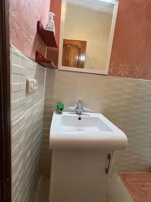 a bathroom with a sink and a mirror at Joli appartement Ricoflores El Mansouria in O Ben Slimane