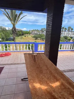 a wooden ramp on a balcony with a palm tree at Chez Bouchra in Mansouria
