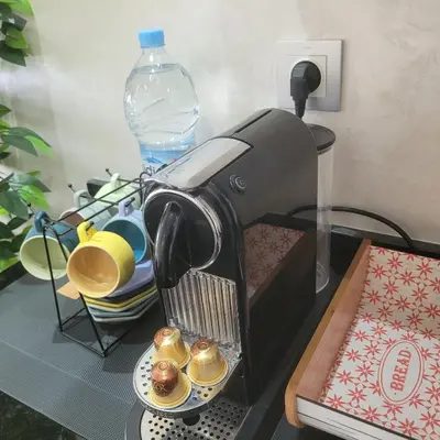 a coffee maker sitting on a table with a plate of muffins at Riviera Escape - Appart Neuf Climatisé avec Balcon à Maarif Anfa in Casablanca