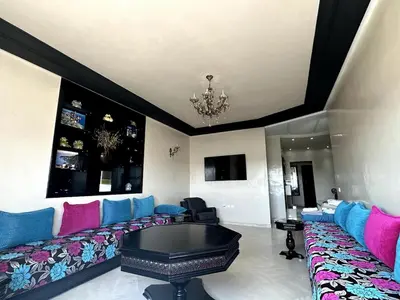 a living room with a couch and a pool table at Beautiful, Bright and modern 3 bedroom apartment in Casablanca