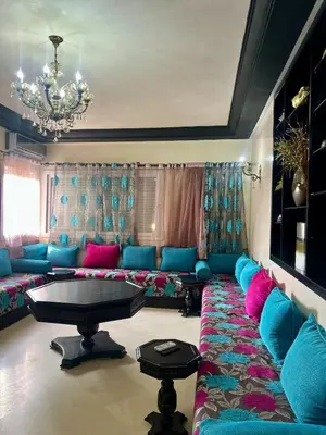 a living room with a couch and a table at Beautiful, Bright and modern 3 bedroom apartment in Casablanca