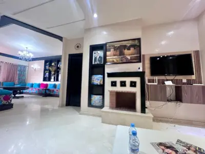 a living room with a fireplace and a tv at Beautiful, Bright and modern 3 bedroom apartment in Casablanca