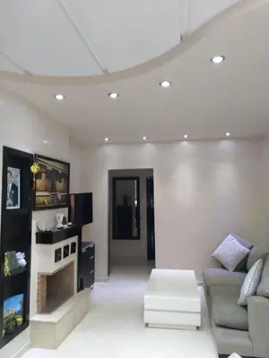 a living room with a couch and a table at Beautiful, Bright and modern 3 bedroom apartment in Casablanca