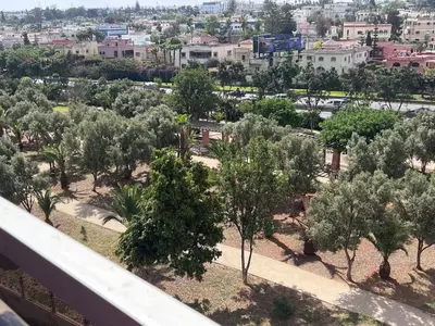 a view of a park with trees and buildings at Beautiful, Bright and modern 3 bedroom apartment in Casablanca
