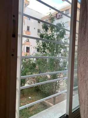 a window with a view of a building at Tms in Sidi Yahia az Zaʼer