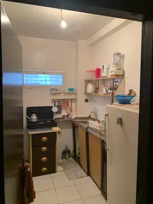 a small kitchen with a sink and a refrigerator at Tms in Sidi Yahia az Zaʼer