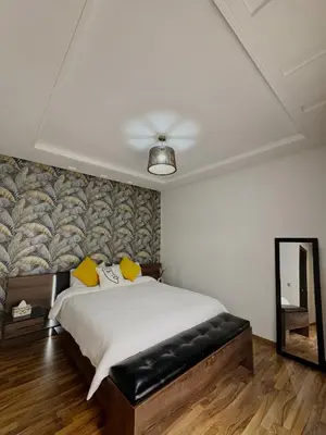 a bedroom with a bed and a mirror and a ceiling at Urban square - comfortable, sunny, and fully equipped in Casablanca