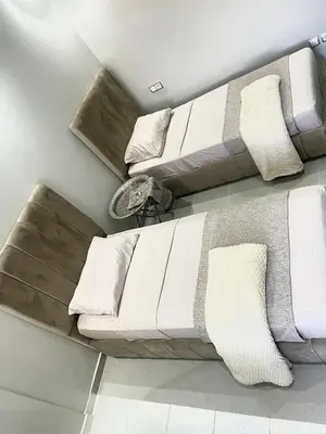 a living room with a white couch with pillows at L oasis cachée à deux pas de plage et piscine in Mohammedia