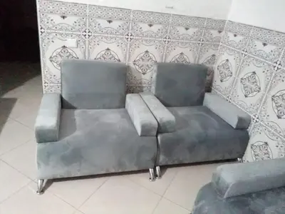 a metal couch in a room with a wall at Bouznika H18 in Bouznika