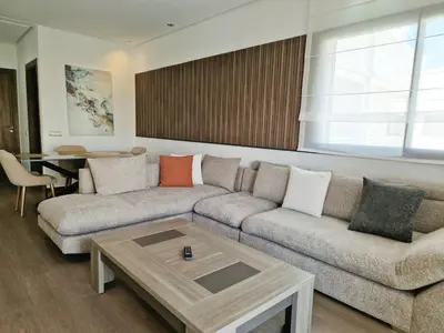 a living room with a couch and a table at Neo Home in Bouznika