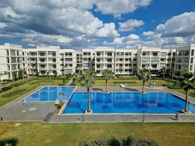 a large apartment building with a large swimming pool at Neo Home in Bouznika