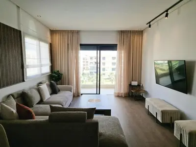 a living room with a couch and a table at Neo Home in Bouznika
