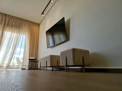 a living room with two chairs and a flat screen tv at Neo Home in Bouznika