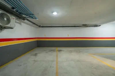 an empty garage with red and yellow stripes on the wall at Les Princesses studio, self check-in, parking in Casablanca