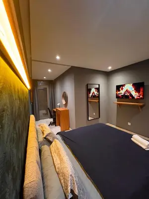 a bedroom with a bed with two televisions on the wall at Lux immo in Casablanca