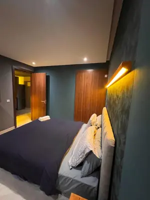 a bedroom with a bed with a blue wall at Lux immo in Casablanca
