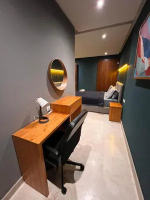 a room with a desk and a bedroom with a bed at Lux immo in Casablanca