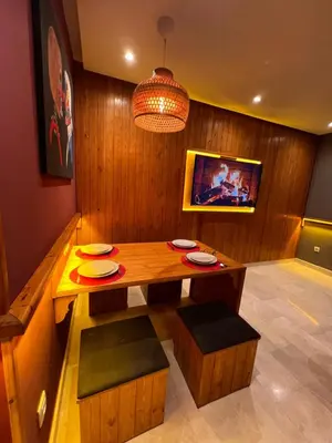 a dining room with a wooden table and chairs at Lux immo in Casablanca