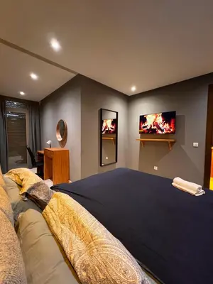 a bedroom with a large bed with two televisions on the wall at Lux immo in Casablanca