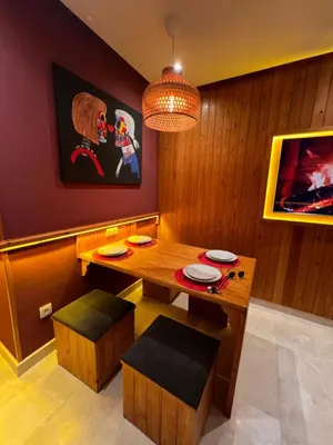 a dining room with a wooden table and chairs at Lux immo in Casablanca