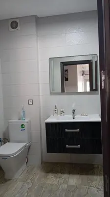 a bathroom with a toilet and a sink and a mirror at La Siesta Beach Resort in Mohammedia