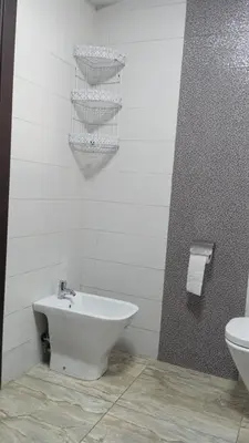 a white bathroom with a sink and a toilet at La Siesta Beach Resort in Mohammedia
