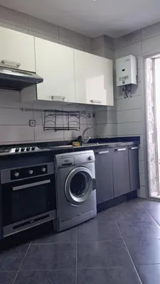 a kitchen with a washing machine and a washer at La Siesta Beach Resort in Mohammedia